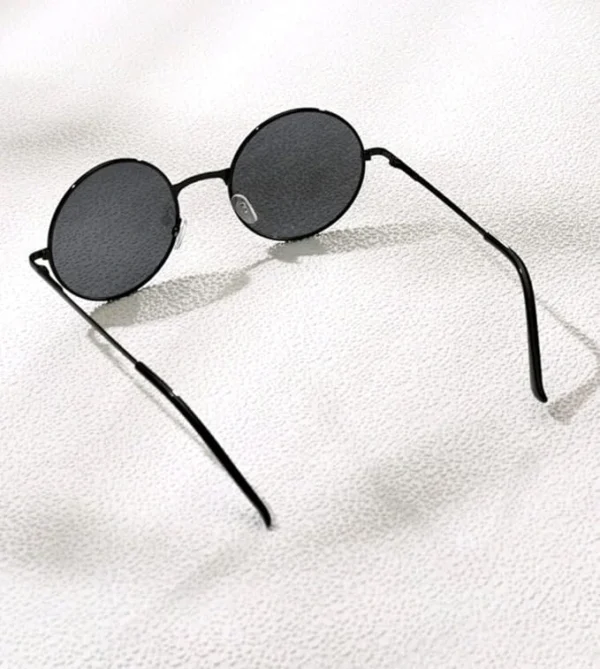 Black round sunglasses with a metal frame and dark lenses.