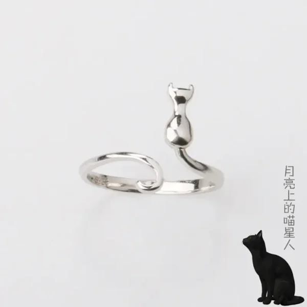 A silver ring featuring a cat sitting upright with its tail curled around the band.